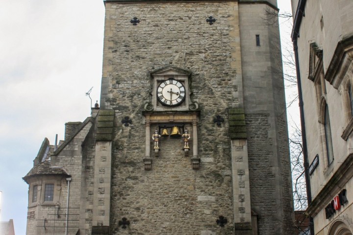 a clock tower in front of a brick building