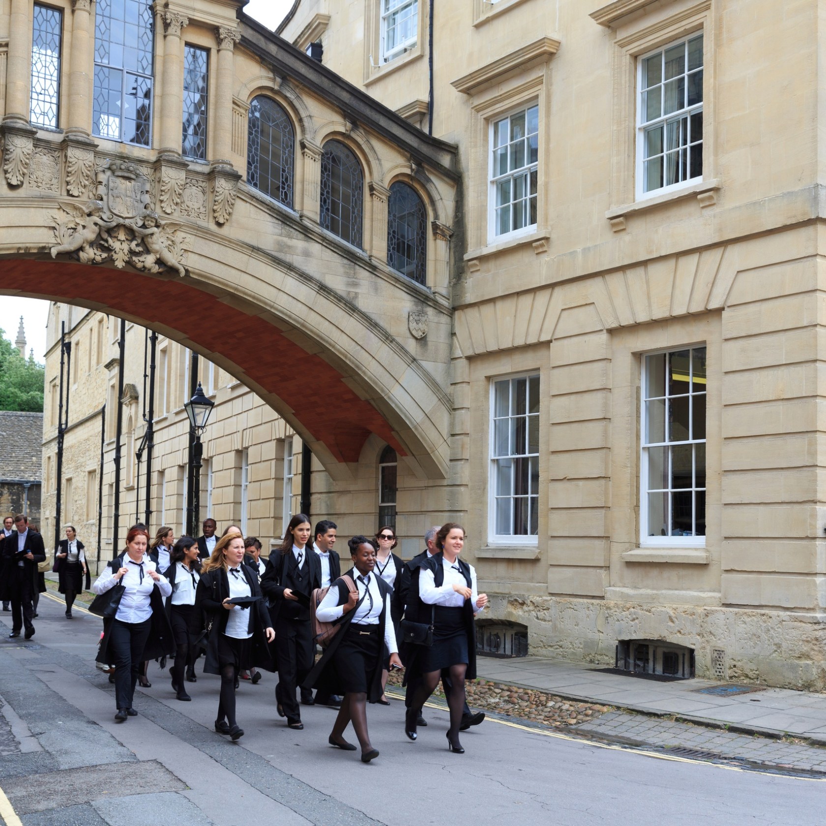 a group of people walking in front of a building