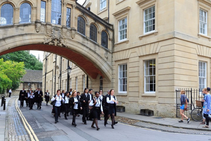 a group of people walking in front of a building