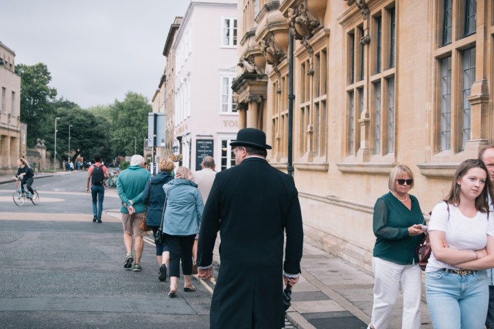 a group of people walking on a city street
