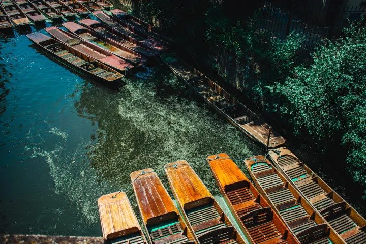 a group of punts parked on a canal