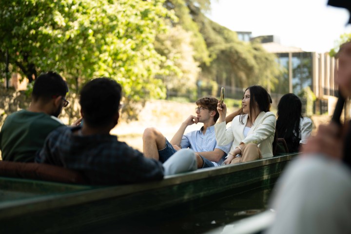 Group of people relaxing in a boat on a sunny day.