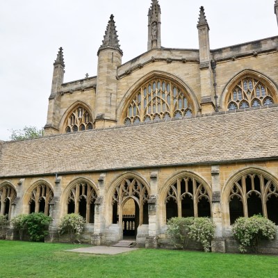 a large stone building with grass in front