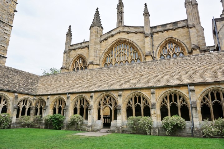 a large stone building with grass in front
